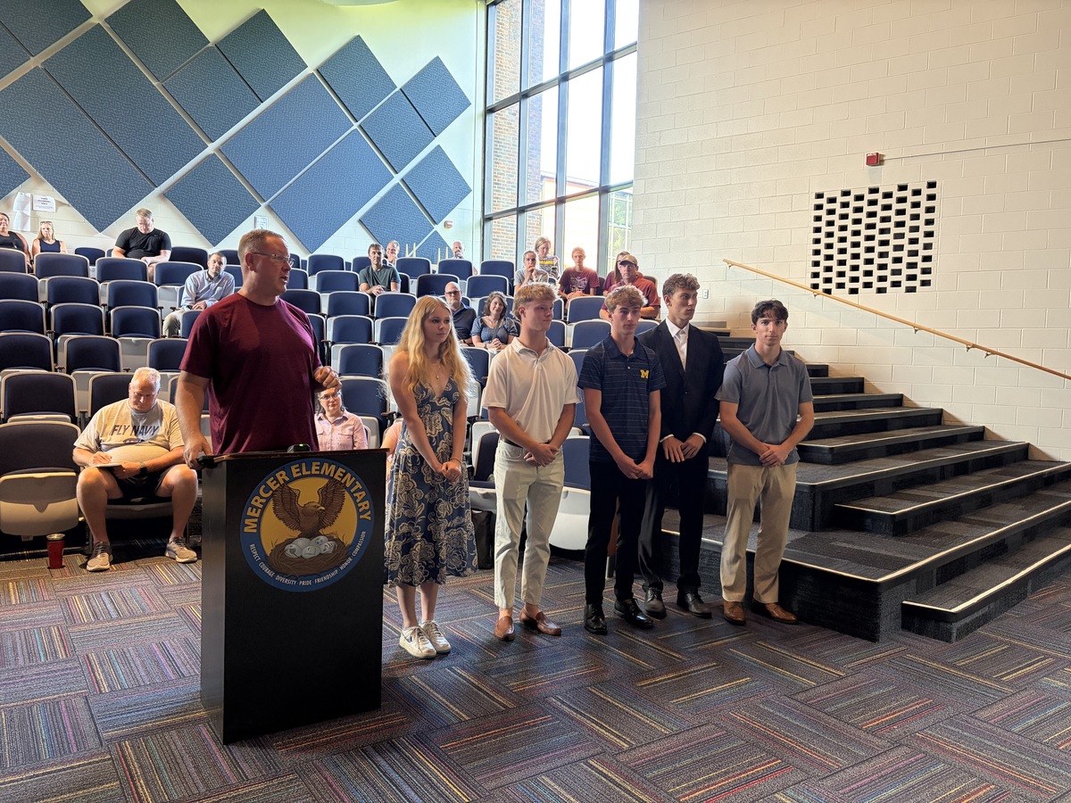 Turpin Spartan student-athletes stand for recognition at a Board of Education Meeting